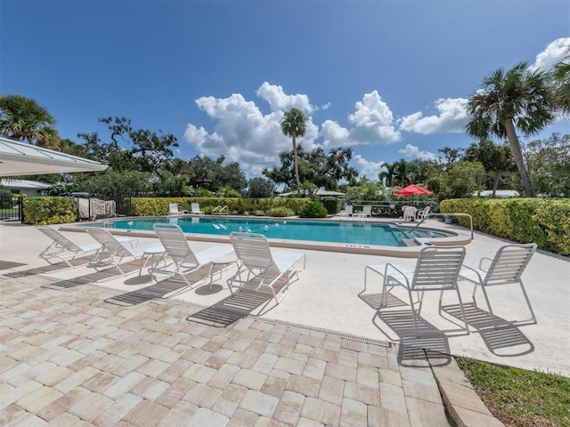 pool featuring a patio and fence