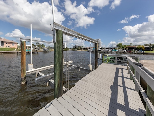 view of dock with boat lift and a water view