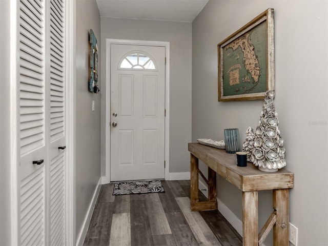 entrance foyer featuring wood finished floors and baseboards