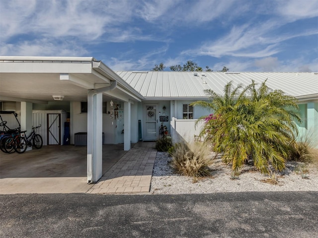 view of front facade with metal roof and a carport