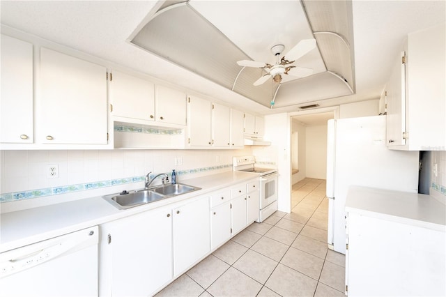 kitchen featuring white cabinetry, sink, white appliances, and a raised ceiling