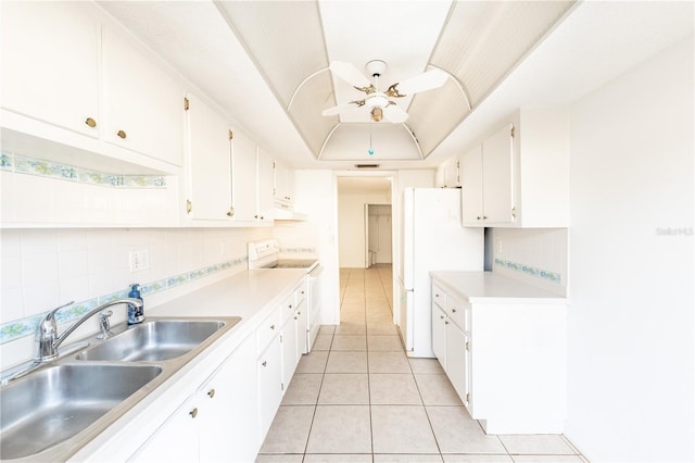 kitchen featuring tasteful backsplash, white cabinetry, sink, a raised ceiling, and white appliances