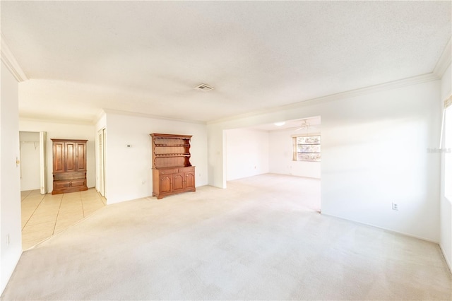 unfurnished living room with crown molding, light carpet, and a textured ceiling