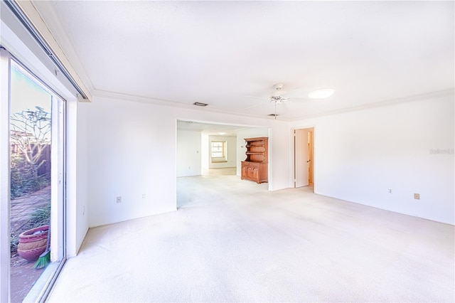 unfurnished room featuring crown molding, light colored carpet, and ceiling fan