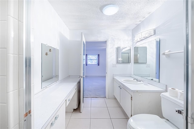 bathroom with vanity, tile patterned floors, a textured ceiling, and toilet