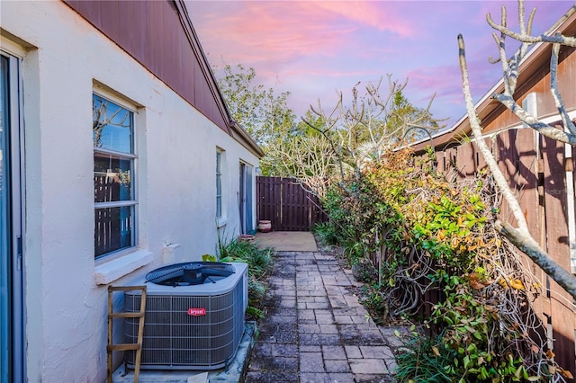 patio terrace at dusk featuring central AC