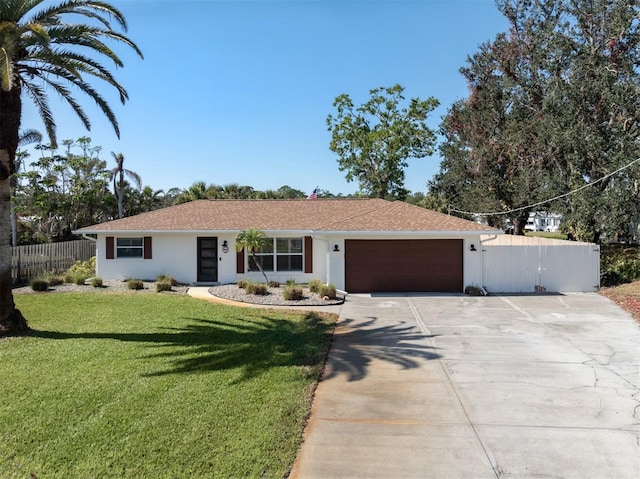 ranch-style house featuring a garage and a front lawn