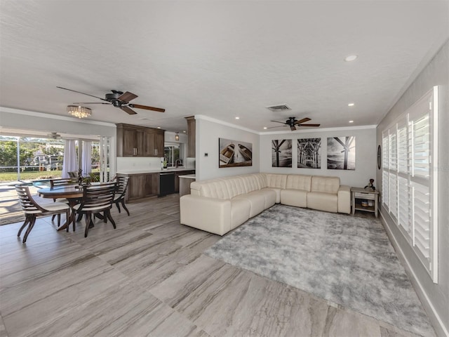 living room with crown molding, a textured ceiling, and ceiling fan