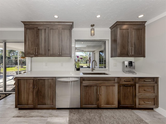 kitchen with tasteful backsplash, sink, stainless steel dishwasher, dark brown cabinets, and a textured ceiling