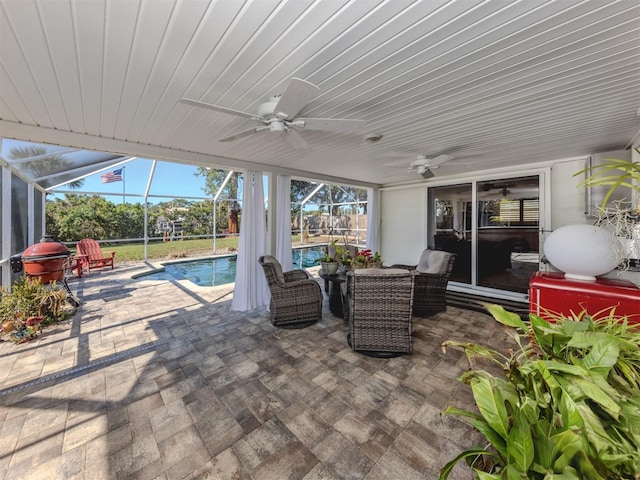 view of patio / terrace with an outdoor hangout area, ceiling fan, and glass enclosure