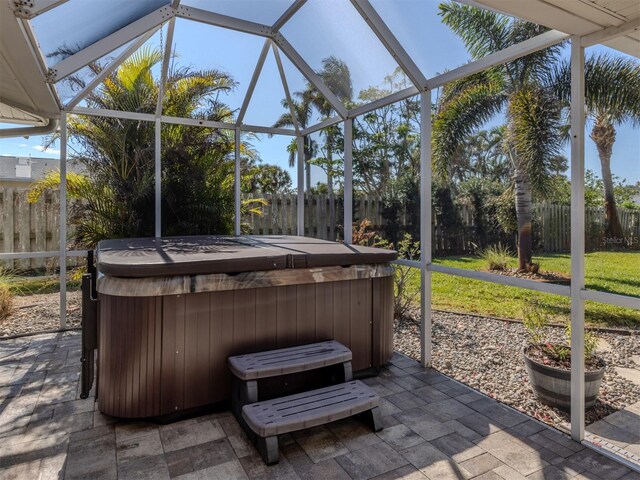 sunroom featuring a hot tub