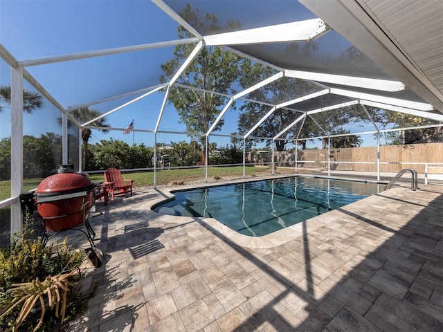 view of swimming pool featuring a lanai and a patio