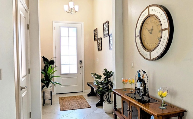 doorway to outside featuring light tile patterned floors and a notable chandelier