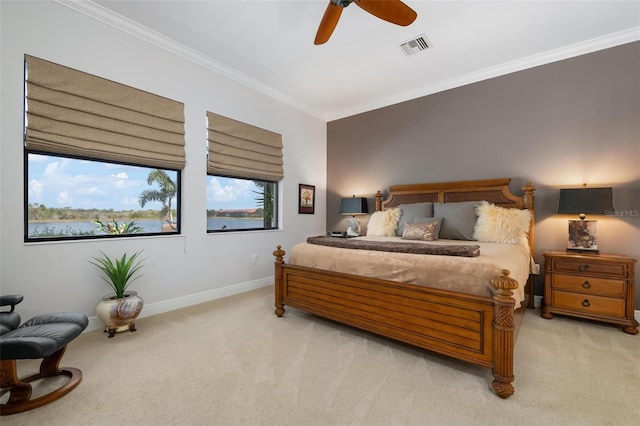 bedroom with light carpet, crown molding, and ceiling fan