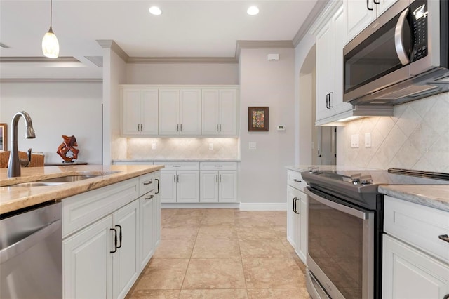 kitchen with white cabinetry, appliances with stainless steel finishes, light stone countertops, and sink