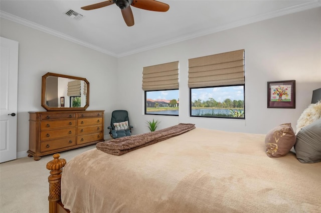 carpeted bedroom with ceiling fan and ornamental molding