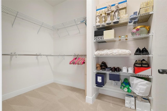 spacious closet with carpet floors