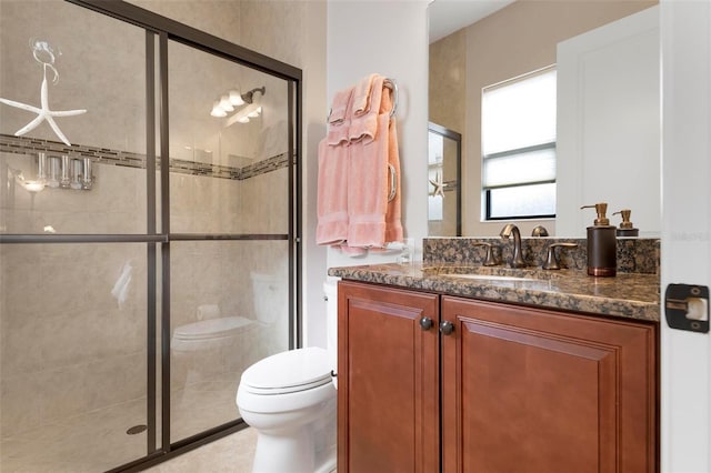 bathroom with vanity, an enclosed shower, and toilet