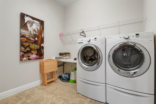 clothes washing area featuring washing machine and dryer and light tile patterned flooring