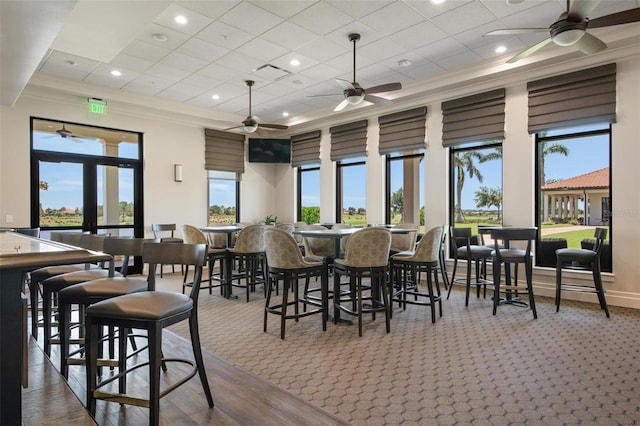 dining room with crown molding, a towering ceiling, and a tray ceiling