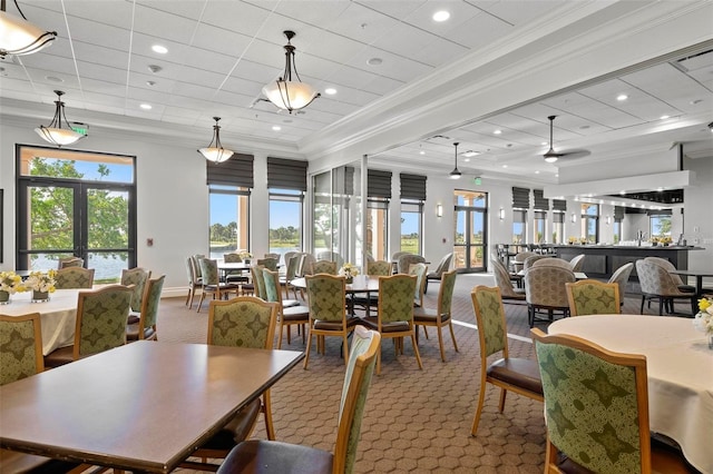 dining area featuring crown molding, a healthy amount of sunlight, and carpet flooring