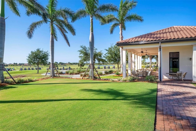 view of yard featuring ceiling fan and a patio area