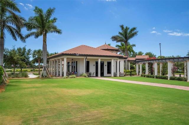 rear view of house featuring a yard