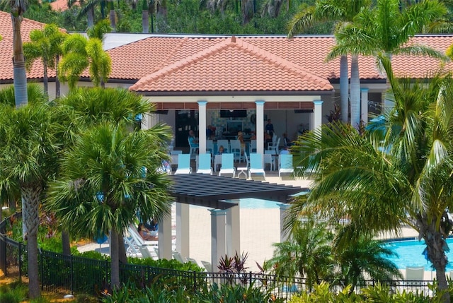 back of property featuring a fenced in pool and a patio area