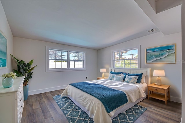 bedroom with dark hardwood / wood-style floors