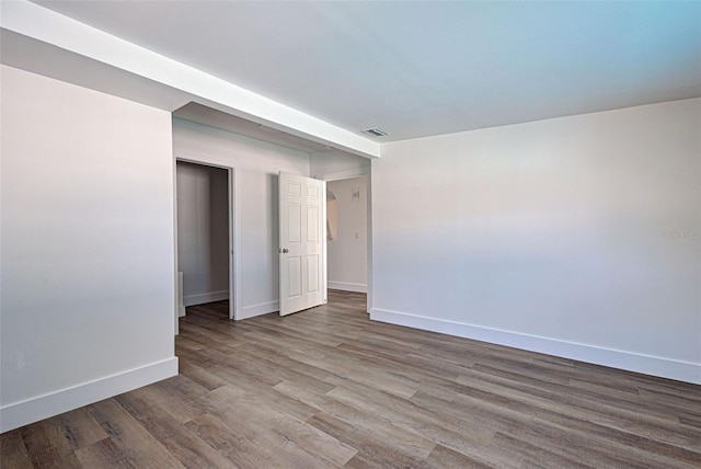 spare room with wood-type flooring