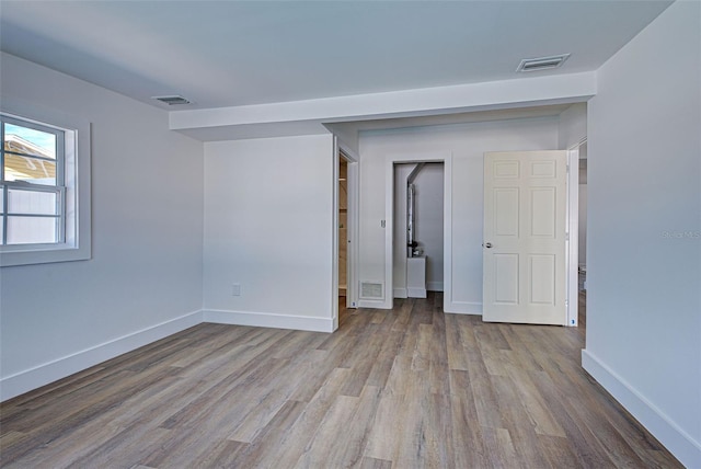 unfurnished room with light hardwood / wood-style flooring