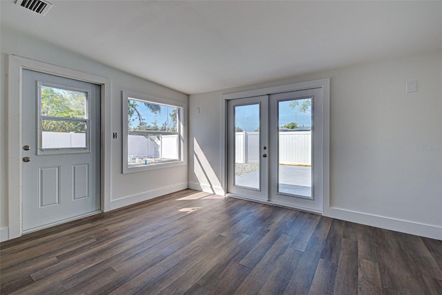 doorway to outside with dark wood-type flooring and french doors