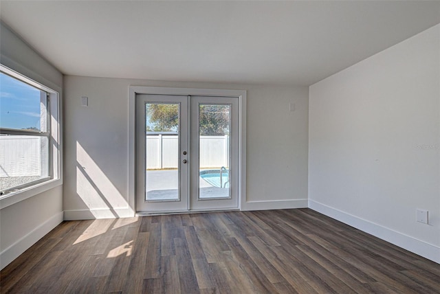 spare room featuring dark hardwood / wood-style floors and french doors