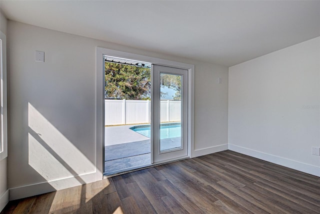 spare room featuring dark wood-type flooring