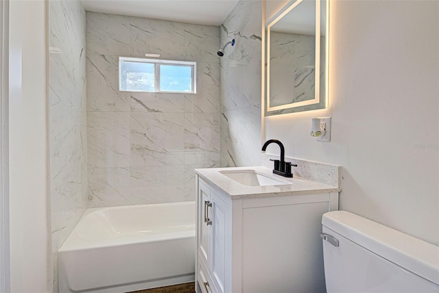 full bathroom featuring vanity, toilet, and tiled shower / bath combo