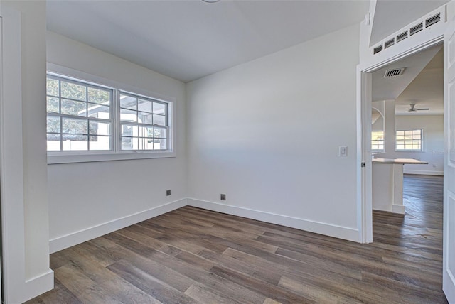 spare room with dark wood-type flooring