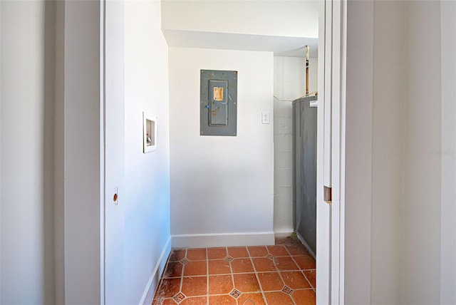 hall with dark tile patterned floors and electric panel