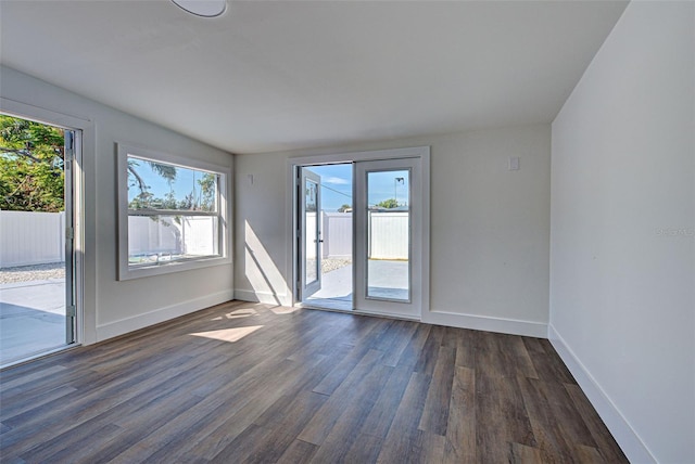 unfurnished room featuring dark wood-type flooring