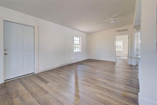 unfurnished room with plenty of natural light and light wood-type flooring