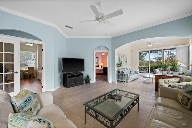 tiled living room featuring crown molding and ceiling fan