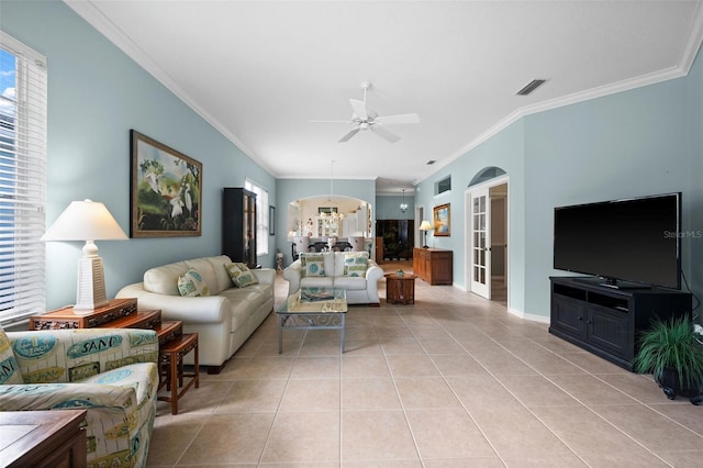 tiled living room featuring ornamental molding and ceiling fan