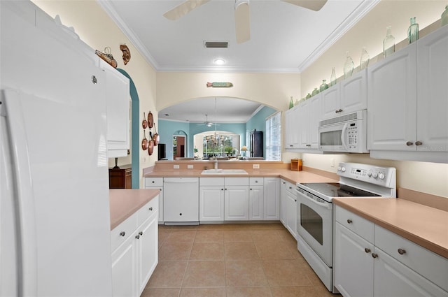 kitchen featuring white appliances, sink, light tile patterned floors, and white cabinets