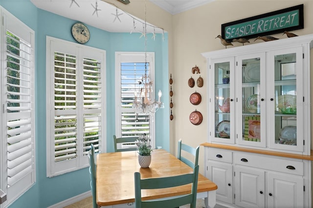 dining area featuring ornamental molding and a notable chandelier