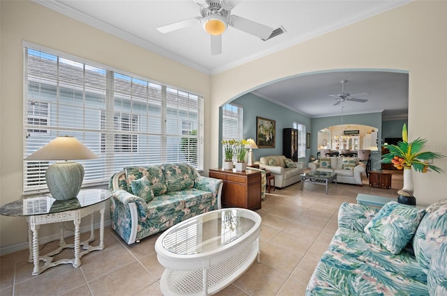 living room featuring ornamental molding, light tile patterned floors, and ceiling fan