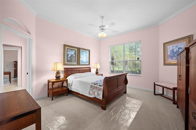 bedroom featuring crown molding, light colored carpet, and ceiling fan