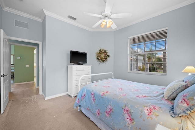 carpeted bedroom with ceiling fan and ornamental molding