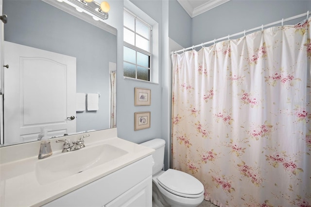 bathroom with crown molding, vanity, and toilet