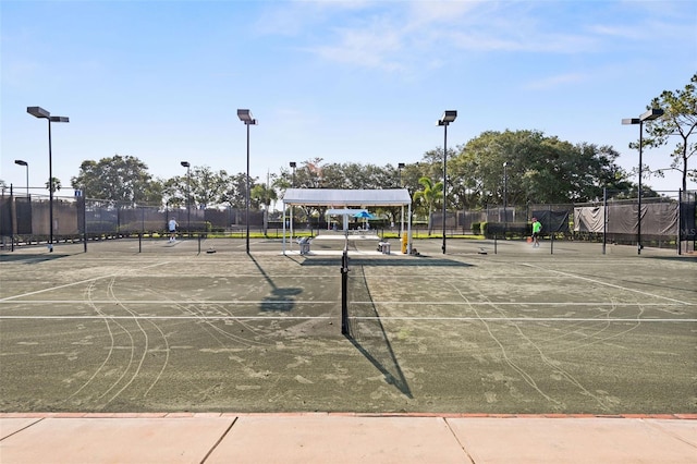 view of home's community featuring basketball court