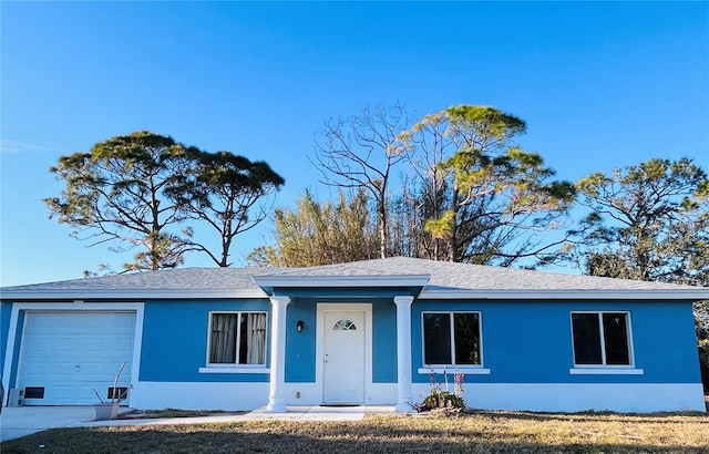 ranch-style home featuring a garage and a porch