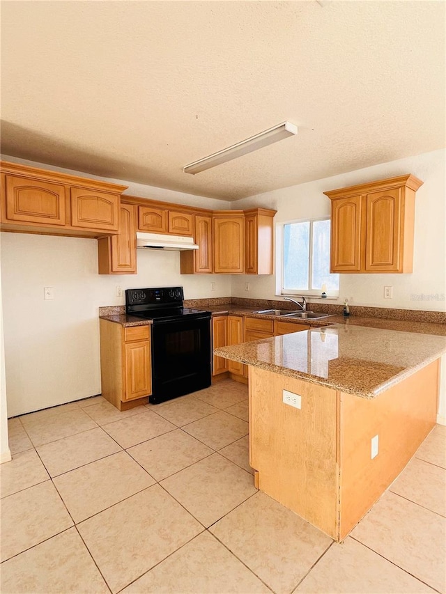 kitchen with black electric range oven, light tile patterned floors, sink, light stone counters, and kitchen peninsula